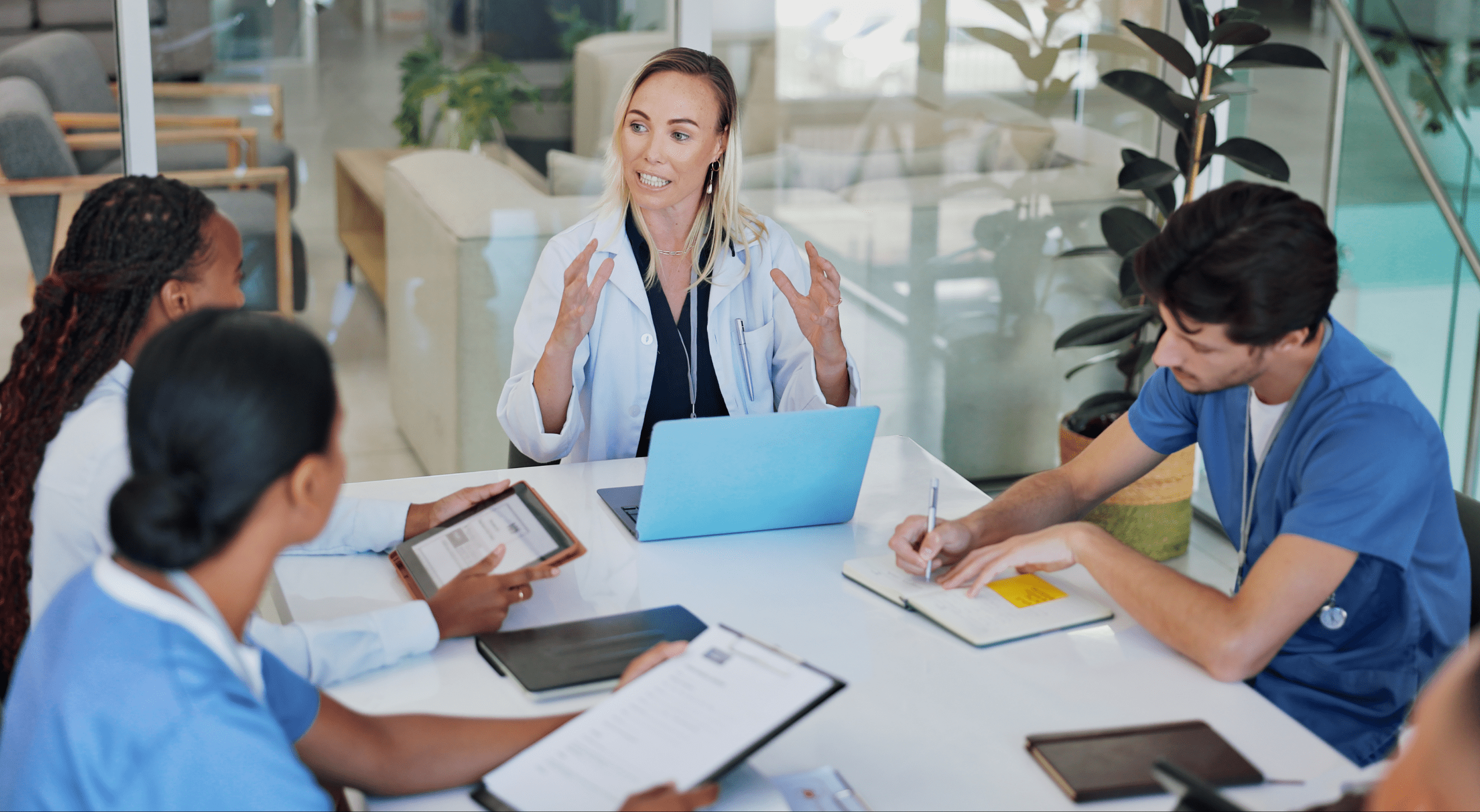 A team of medical professionals speak at a table