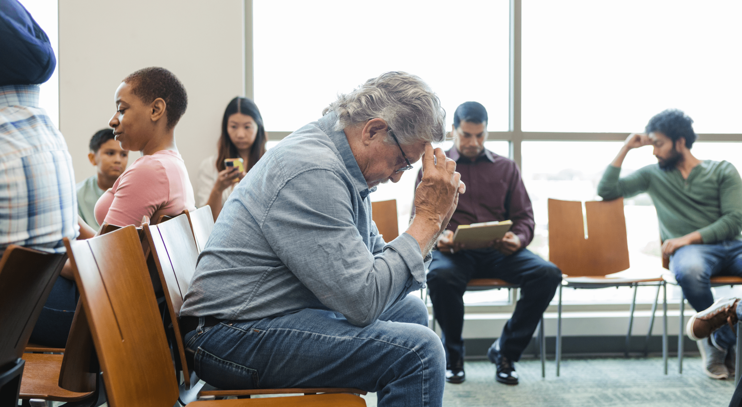 A man looking stressed in a medical waiting room 